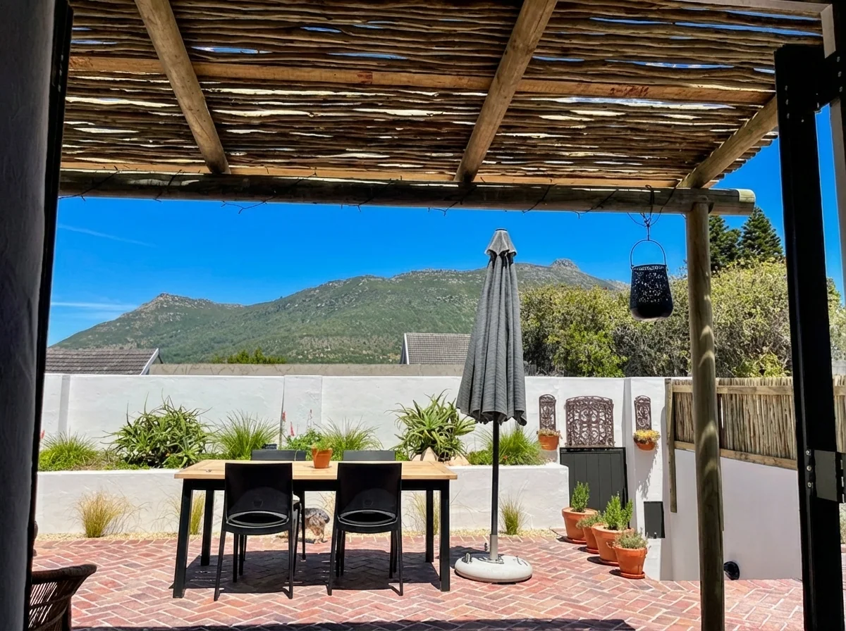 Ibis Cottage patio dining seen from inside, opening to the garden